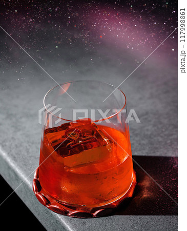 Red alcohol cocktail with ice on dark background Red alcohol cocktail with ice on dark background 117998861