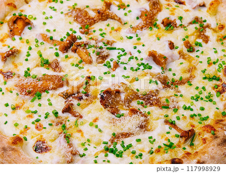 Freshly baked gourmet pizza on wooden board 117998929