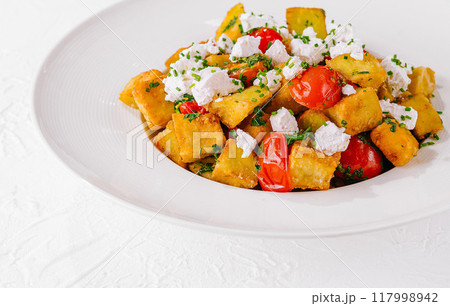 Fresh homemade polenta with tomatoes and feta 117998942