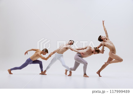 Dancers move in graceful sequence, emphasizing fluidity and connection as they stretch and reach towards each other, forming cohesive unit. Dancers move in graceful sequence, emphasizing fluidity and connection as they stretch and reach towards each other, forming cohesive unit. 117999489