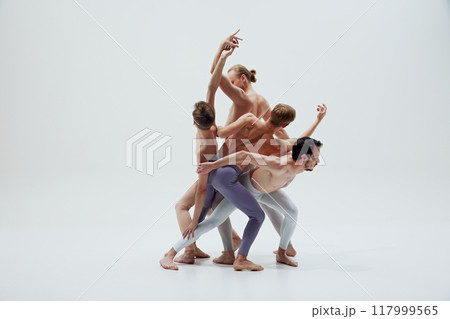 Ballet dancers' bodies form composition, each movement reflecting balance and unity against white studio background. Ballet dancers' bodies form composition, each movement reflecting balance and unity against white studio background. 117999565