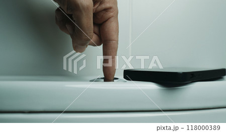 smartphone and man flushing the toilet 118000389