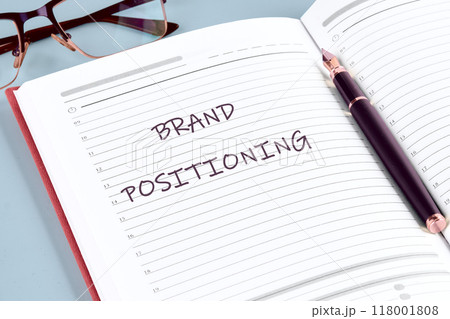 Economic concept. The inscription BRAND POSITIONING in the notebook of a businessman, manager, top manager Economic concept. The inscription BRAND POSITIONING in the notebook of a businessman, manager, top manager 118001808