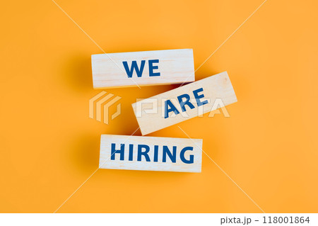 Business and Now Hiring concept. Copy space. Words WE ARE HIRING on wooden blocks with a yellow-orange background 118001864
