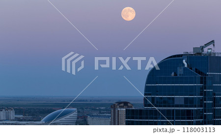 Nazarbayev Center and blue tower, after Sunset with full moon rising. Astana, Kazakhstan Nazarbayev Center and blue tower, after Sunset with full moon rising. Astana, Kazakhstan 118003113