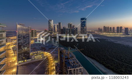 Buildings on Al Reem island in Abu Dhabi day to night timelapse from above. 118003243