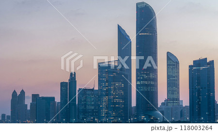 Abu Dhabi city skyline with skyscrapers before sunrise with water reflection night to day timelapse Abu Dhabi city skyline with skyscrapers before sunrise with water reflection night to day timelapse 118003264