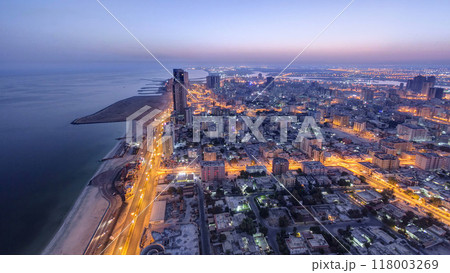 Cityscape of Ajman from rooftop night to day timelapse. Ajman is the capital of the emirate of Ajman in the United Arab Emirates. Cityscape of Ajman from rooftop night to day timelapse. Ajman is the capital of the emirate of Ajman in the United Arab Emirates. 118003269