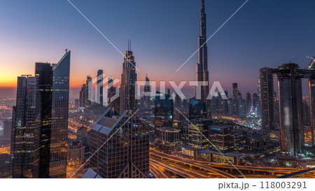 Dubai downtown skyline with tallest skyscrapers and busiest traffic on highway intersection night to day timelapse 118003291