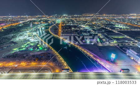 Dubai water canal with footbridge aerial night timelapse from Downtown skyscrapers rooftop 118003533