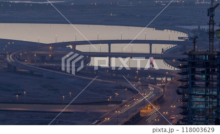 Traffic on a busy intersection in Dubai downtown night to day timelapse. Top view from above 118003629