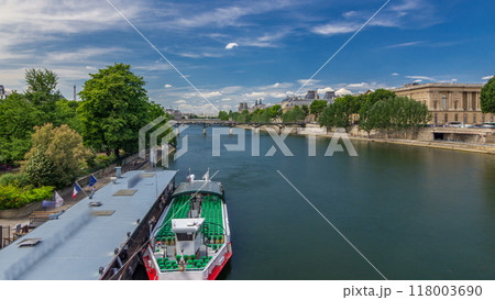 Touristic boat passes below Pont des Arts and stop on boat station on Seine river timelapse hyperlapse in Paris. 118003690