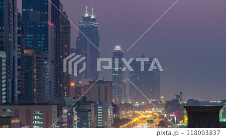 Downtown Dubai towers day to night timelapse. Aerial view of Sheikh Zayed road with skyscrapers after sunset. Downtown Dubai towers day to night timelapse. Aerial view of Sheikh Zayed road with skyscrapers after sunset. 118003837
