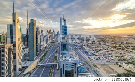 Dubai skyscrapers sunset timelapse evening time. Dubai Metro station and traffic on Sheikh Zayed Road 118003864