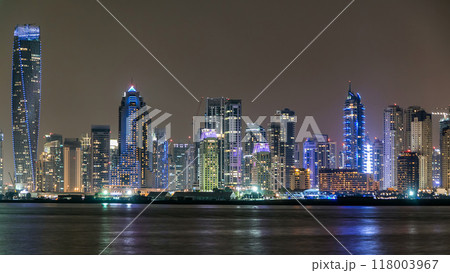 Dubai Marina skyline night timelapse as seen from island in Dubai, UAE. 118003967