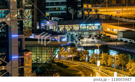Buildings of Jumeirah Lakes Towers with traffic on the road night timelapse. 118003987