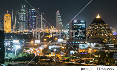 Dubai downtown skyline timelapse at night. Rooftop view of Sheikh Zayed road with numerous illuminated towers. Dubai downtown skyline timelapse at night. Rooftop view of Sheikh Zayed road with numerous illuminated towers. 118003995