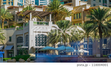 Fountain and palms timelapse at the Marina walk during day time. Dubai, UAE 118004001