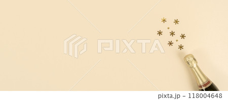 Champagne bottle with confetti snowflakes. New Year, Christmas, celebration concept. Flat lay. Banner. Copy space 118004648