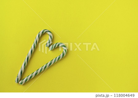 heart shaped green candy canes on gray background 118004649