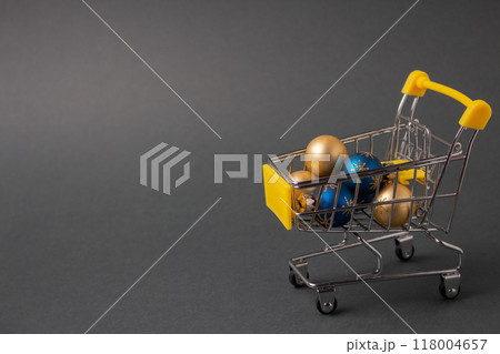 Christmas balls in mini shopping trolley for Christmas and New Year festival concept. High quality photo 118004657