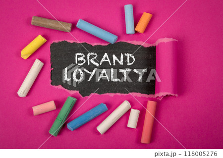 Brand Loyalty. Text under torn purple paper on a blackboard 118005276