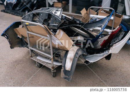 Close-up of mixed scrap metal pile at auto wrecking yard. Dismantling of old automobiles at industrial scrapyard. Colored jumble of iron waste as old car body, various leftover recyclable materials. Close-up of mixed scrap metal pile at auto wrecking yard. Dismantling of old automobiles at industrial scrapyard. Colored jumble of iron waste as old car body, various leftover recyclable materials. 118005738