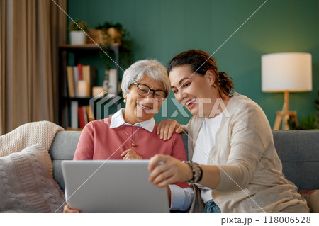 Young and senior women are using laptop Young and senior women are using laptop 118006528