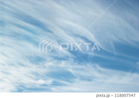 The sky is a fresh blue with intricate patterns of cirrus clouds. Cirrus clouds in the sky portend a change in weather. 118007547