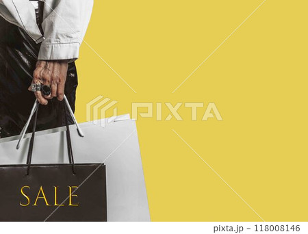 stylish hand of old woman adorned with statement rings, shopping bags with sale anticipation of grabbing the best deals 118008146