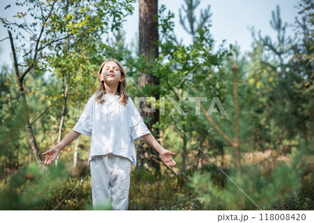 A teenage girl who breathes fresh air and relieves stress in the forest. A teenage girl who breathes fresh air and relieves stress in the forest. 118008420