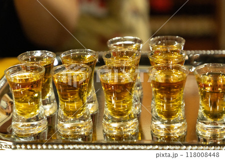 Strong alcoholic drink in small glasses. Strong alcoholic drink in small glasses. 118008448