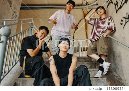 Hanging Out on Urban Staircase with Friends Smiling Hanging Out on Urban Staircase with Friends Smiling 118009324