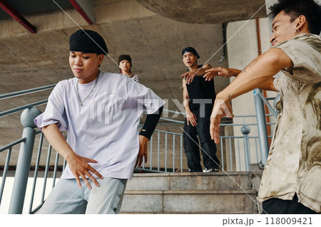 Dancing Group Practicing Hip-Hop Moves Outdoors 118009421