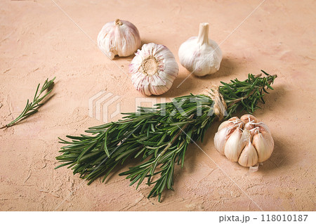 fresh bunch of rosemary with garlic, on a beige background, food concept, 118010187