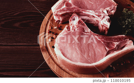 Fresh, raw pork meat, sliced, on a cutting board, with spices, horizontal, rustic style, toning Fresh, raw pork meat, sliced, on a cutting board, with spices, horizontal, rustic style, toning 118010195