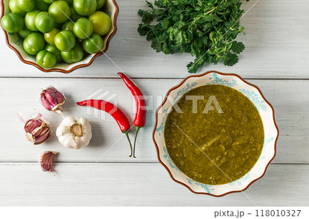 Tkemali sauce, traditional Georgian cuisine, green cherry plum, on a white wooden table, close-up, rustic, food background, no people, selective focus, Tkemali sauce, traditional Georgian cuisine, green cherry plum, on a white wooden table, close-up, rustic, food background, no people, selective focus, 118010327