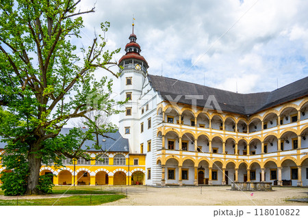 Charming Velke Losiny Chateau courtyard, admiring the elegant architecture and lush greenery on a bright day in Czechia. The historic site showcases its rich cultural heritage. 118010822