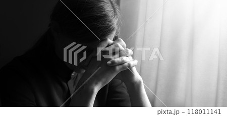 Praying woman at the window 118011141