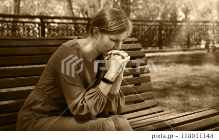 Pretty girl sitting on the bench Pretty girl sitting on the bench 118011148