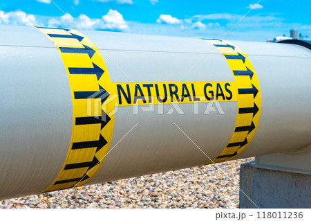A huge diameter gas pipeline with a gas transportation direction indicator and the inscription Natural Gas A huge diameter gas pipeline with a gas transportation direction indicator and the inscription Natural Gas 118011236