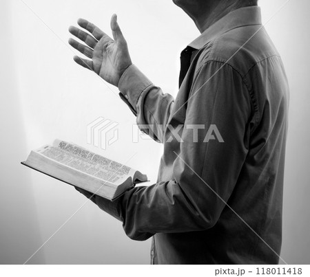 A man with a bible preaches 118011418