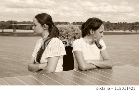 The girls look in different directions with resentment 118011423