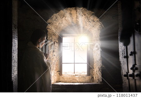 Young girl at old window 118011437