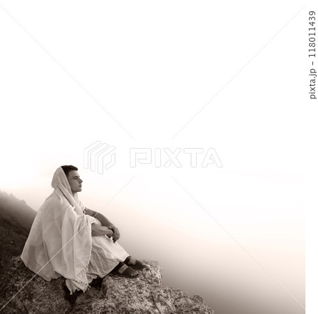 Young man sitting on the rock 118011439