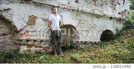 Young man staying at the wall 118011440