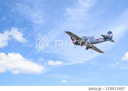 View of an aerobatic plane (aerodyne), in flight under a blue sky with white clouds. flight exhibitions View of an aerobatic plane (aerodyne), in flight under a blue sky with white clouds. flight exhibitions 118011467