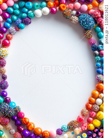 A diverse collection of colorful beads lies arranged in a circular pattern, showcasing various sizes and textures, ideal for jewelry making or artistic projects A diverse collection of colorful beads lies arranged in a circular pattern, showcasing various sizes and textures, ideal for jewelry making or artistic projects 118011621