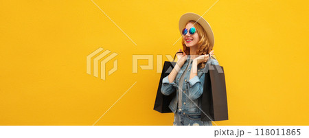 Shopping day, stylish beautiful happy smiling young woman with black shopping bags, wear summer hat 118011865