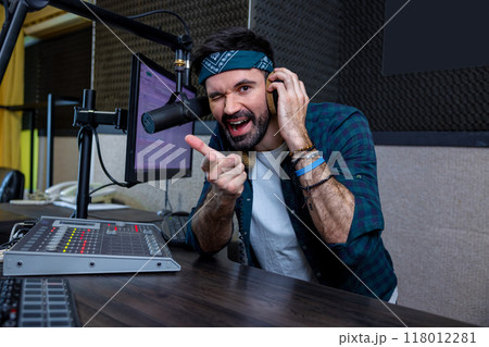 Hipster DJ using recording equipment and digital music creation technology Hipster DJ using recording equipment and digital music creation technology 118012281